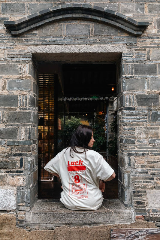 Person sitting in a stone doorway with a building interior visible